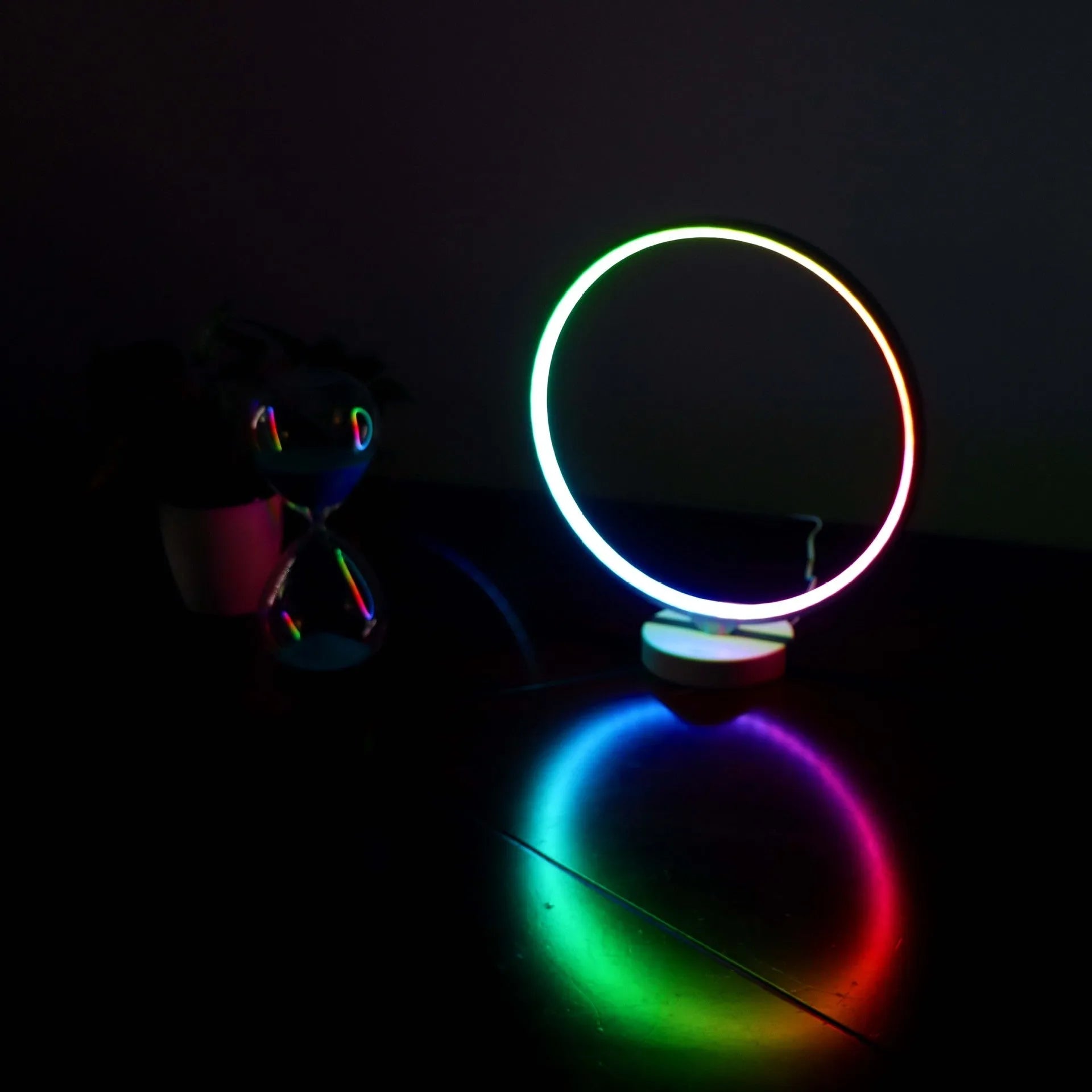 White Full Moon table lamp with remote control on a wooden surface.