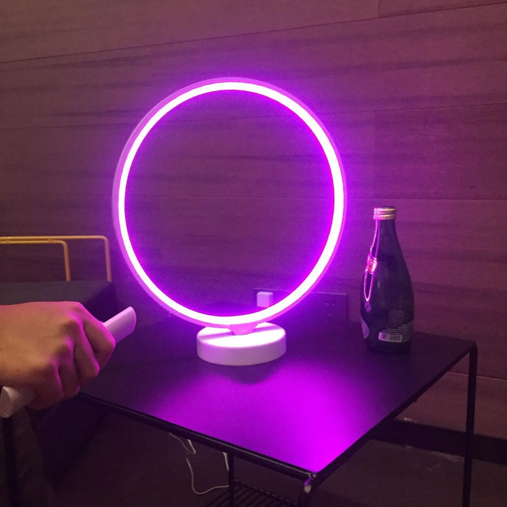 White Full Moon table lamp with remote control on a wooden surface.