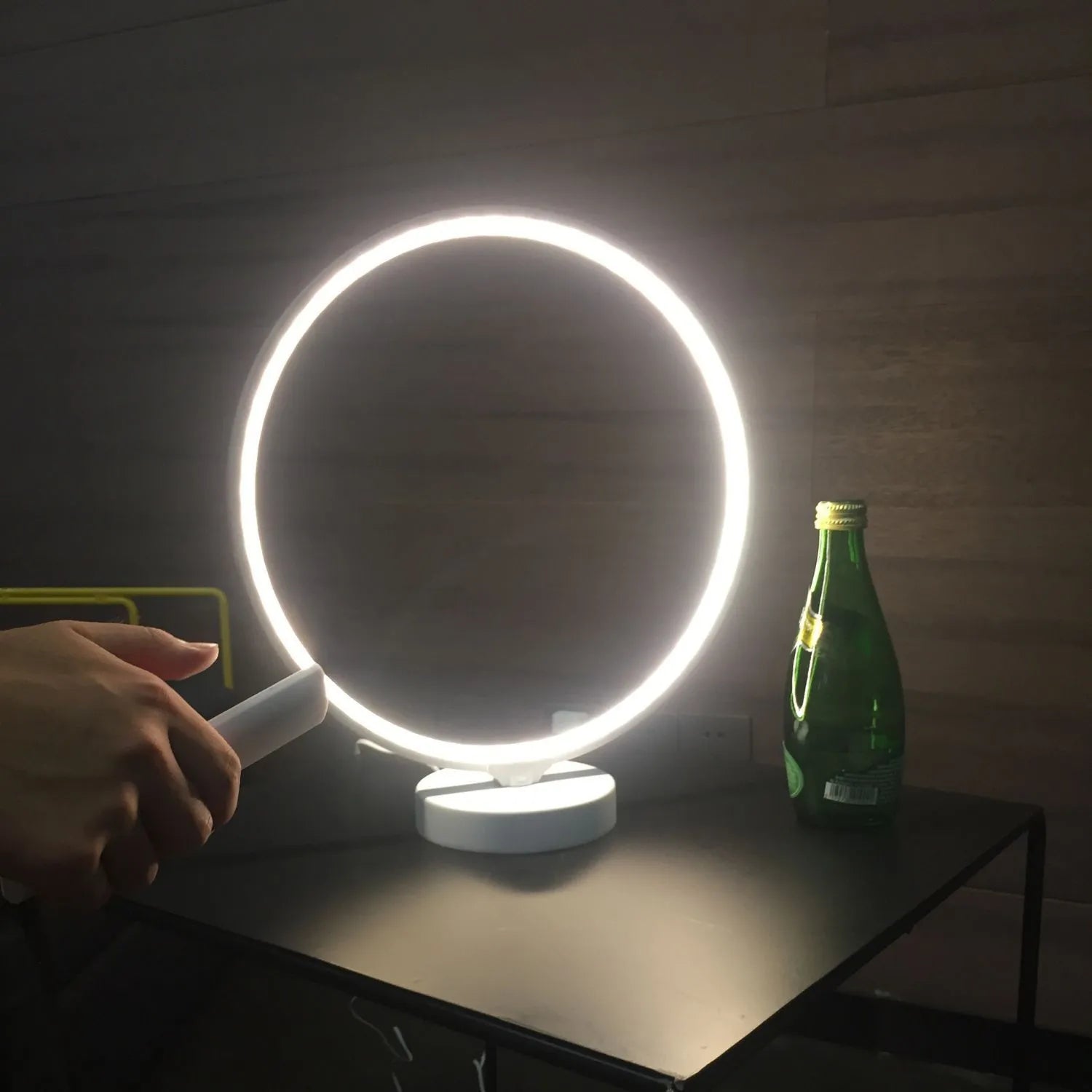 White Full Moon table lamp with remote control on a wooden surface.