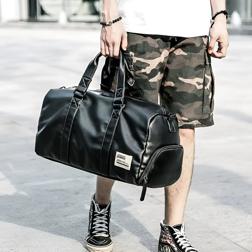 Large black waterproof PU leather sports training bag with multiple internal compartments.