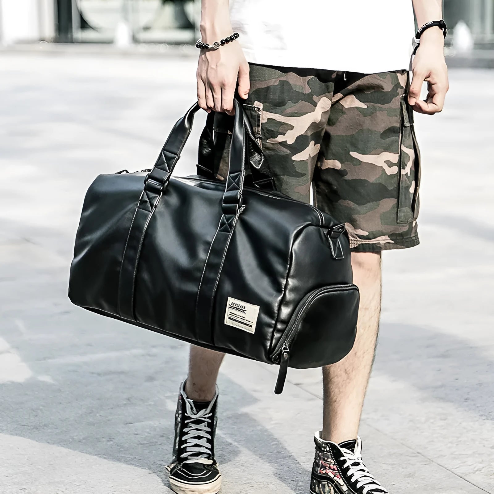 Large black waterproof PU leather sports training bag with multiple internal compartments.