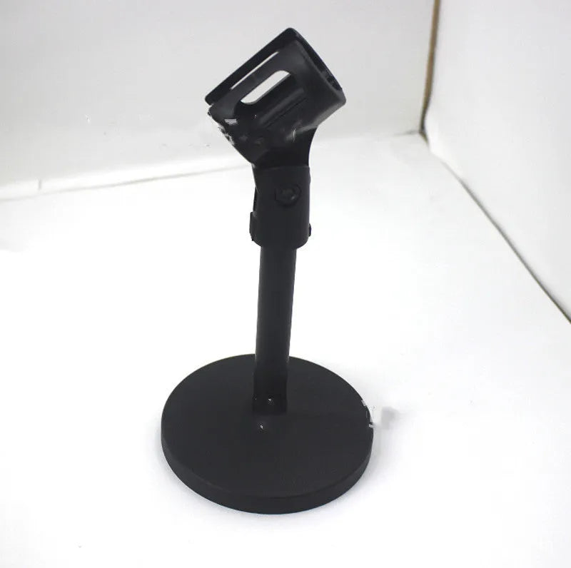 Black metal desktop microphone stand with disc base and plastic clip, 22cm tall.