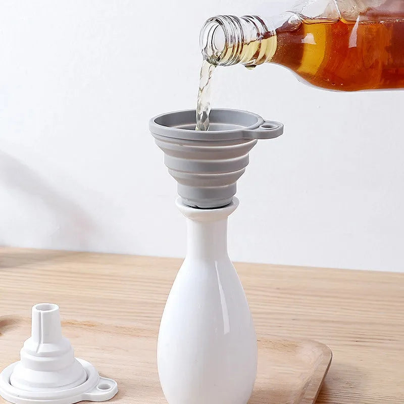 Silicone folding funnel in grey for pouring oil into a bottle in a modern kitchen