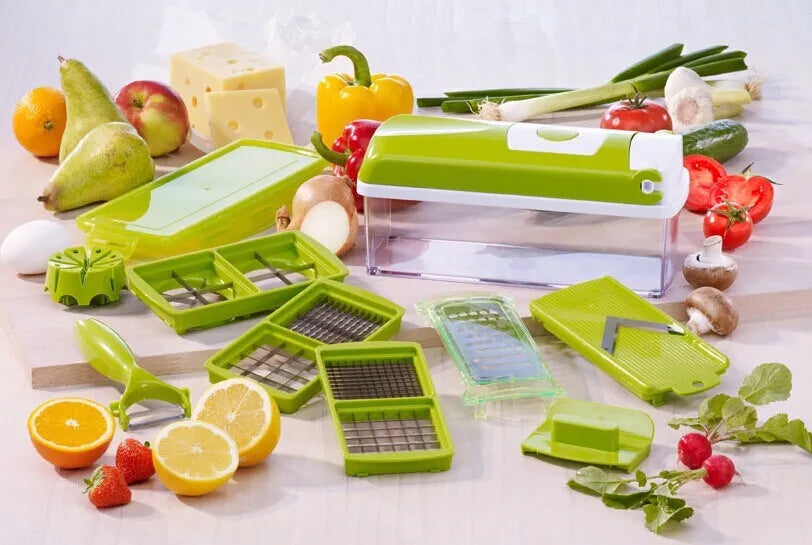 Green manual food chopper with stainless steel blades on a kitchen counter.