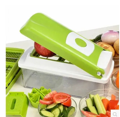 Green manual food chopper with stainless steel blades on a kitchen counter.