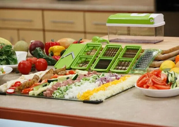 Green manual food chopper with stainless steel blades on a kitchen counter.