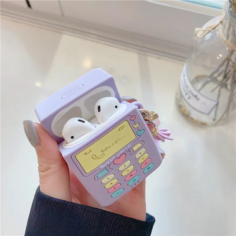 Purple silicone clamshell case for AirPods Pro or AirPods 1 and 2 with a matching fur ball pendant attached.