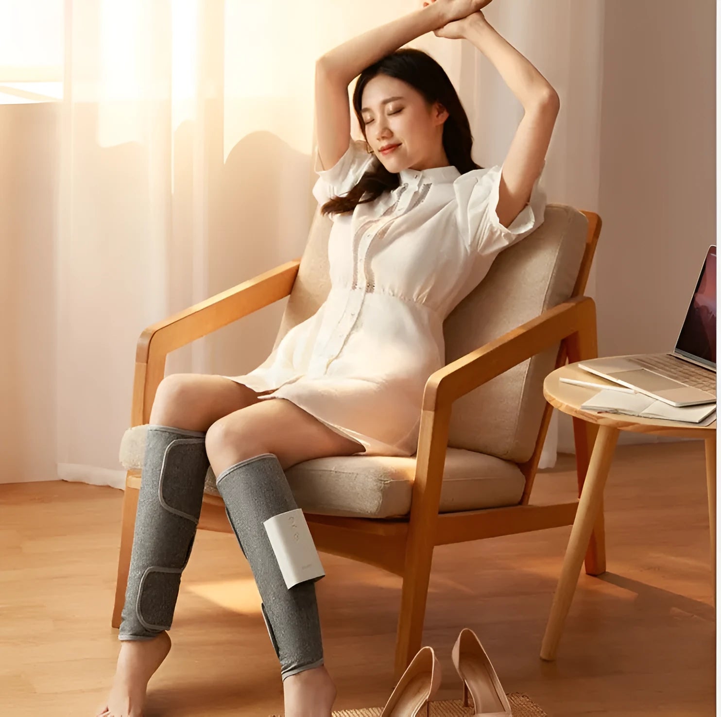 Rechargeable calf air wave leg massager with wireless remote control on a sofa