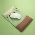 Green kiwi fruit design on a grey cloth wrist support mouse pad with thick silicone base.
