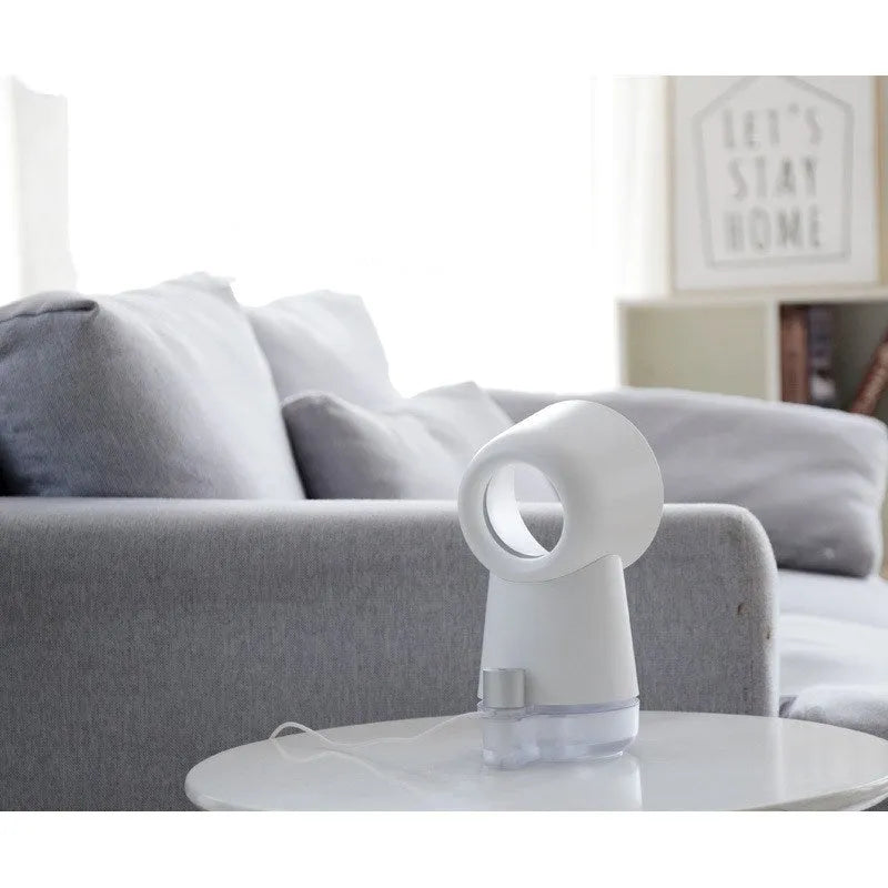 White desktop humidifier with leafless fan and night light on a wooden desk