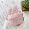 Pink soft silicone AirPods Pro cover with grey plush rabbit ears attached on a white background.