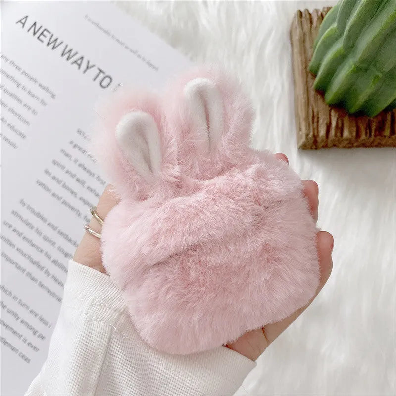 Pink soft silicone AirPods Pro cover with grey plush rabbit ears attached on a white background.