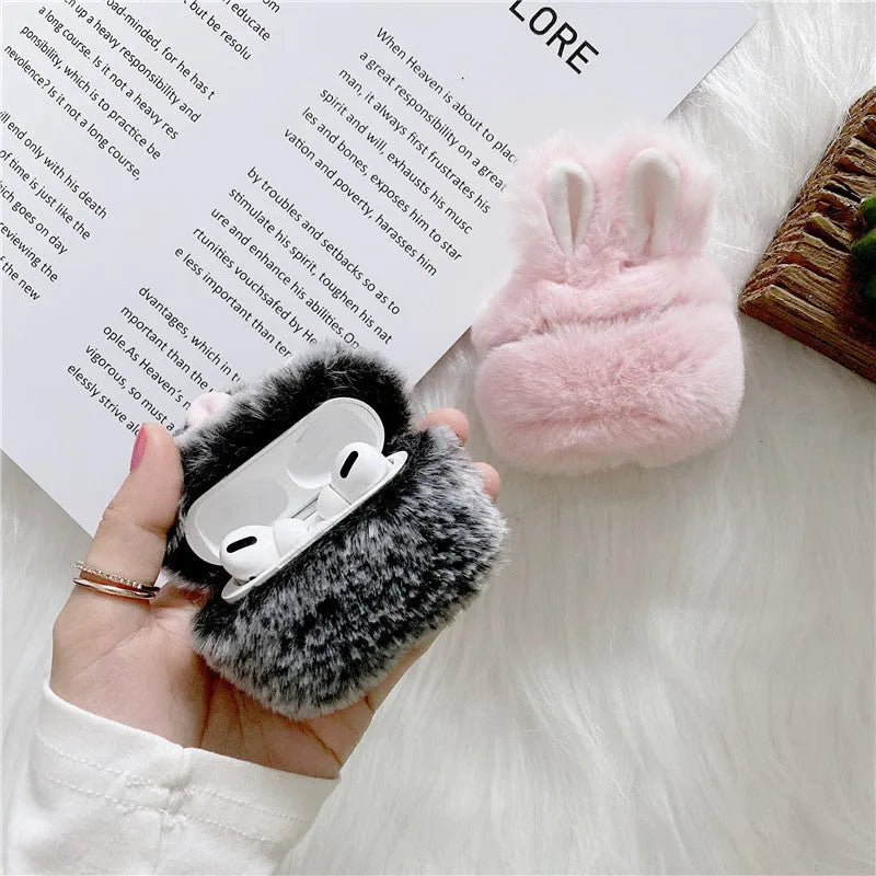 Pink soft silicone AirPods Pro cover with grey plush rabbit ears attached on a white background.