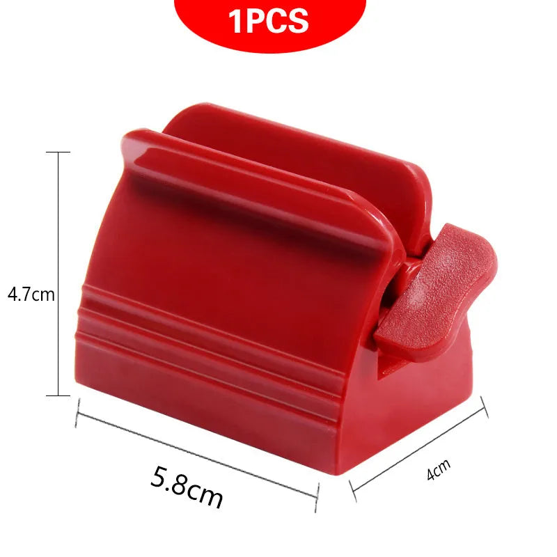Large toothpaste squeezer in white ABS plastic with a toothpaste tube inserted