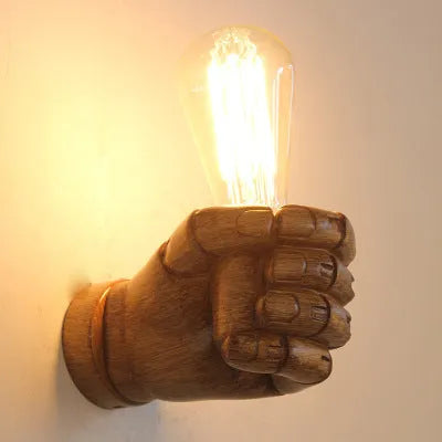 Creative resin fist sculpture wall lamp in black, white, or wood grain finish for left or right hand mounting.