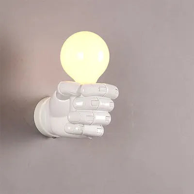 Creative resin fist sculpture wall lamp in black, white, or wood grain finish for left or right hand mounting.