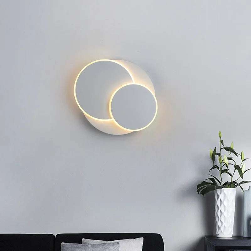 Round acrylic LED wall lamp in black or white with push button switch