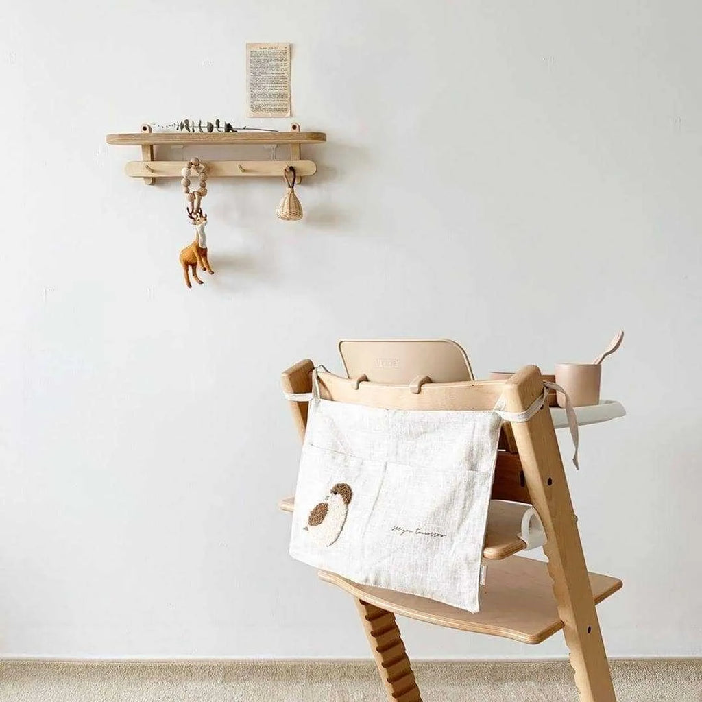 Khaki cotton and linen multi-purpose storage bag hanging beside the bed with single pocket