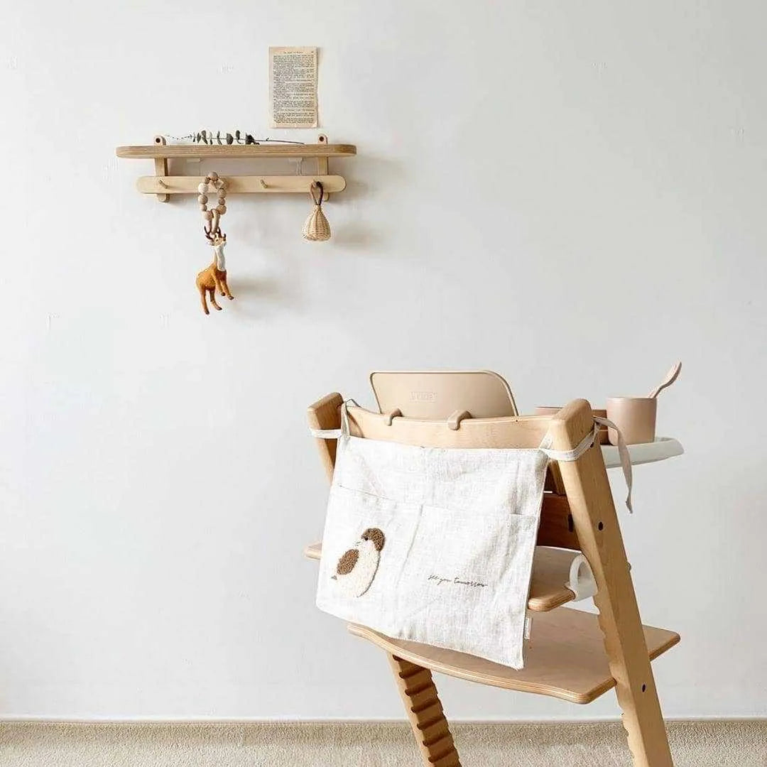 Khaki cotton and linen multi-purpose storage bag hanging beside the bed with single pocket