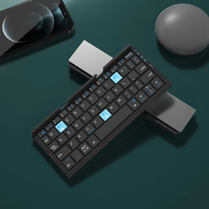 Silver white folding Bluetooth keyboard open with phone on stand and closed showing compact size
