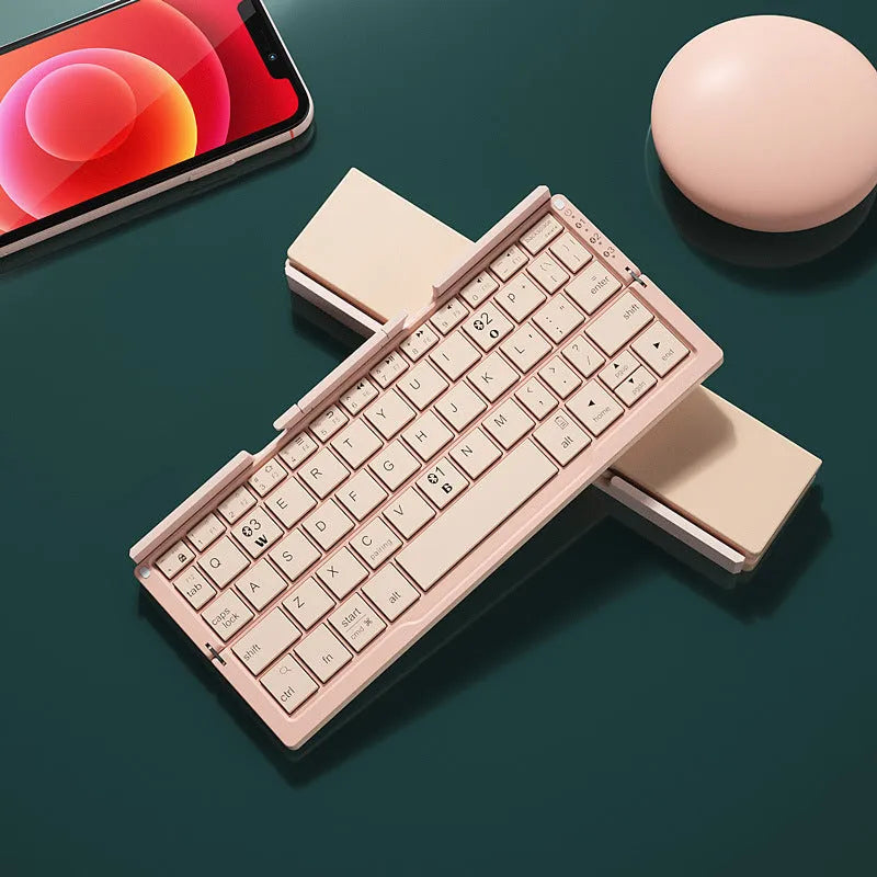 Silver white folding Bluetooth keyboard open with phone on stand and closed showing compact size
