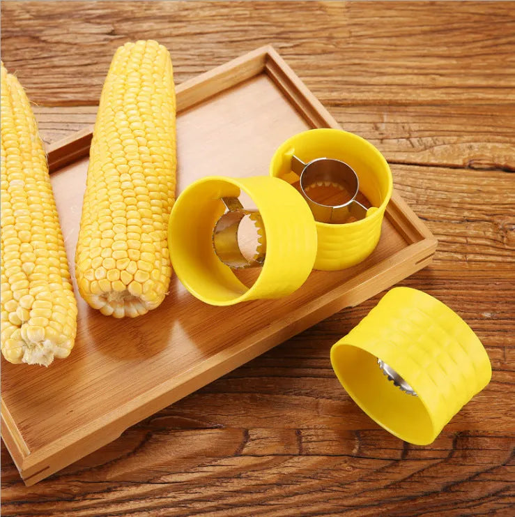Yellow manual corn thresher with corn-shaped design and stainless steel gear for peeling kernels.