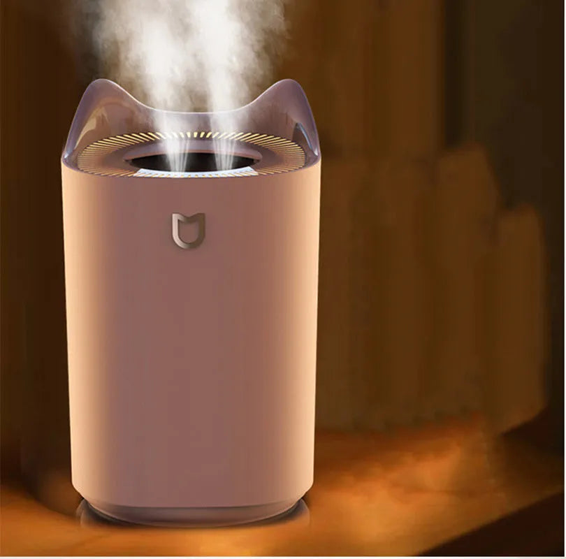 USB-powered double spray humidifier diffuser in coral pink or white with three fog outlets.