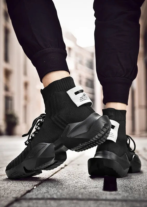 Men's black and white casual sports shoes showing mesh lining and available in sizes 39 to 47