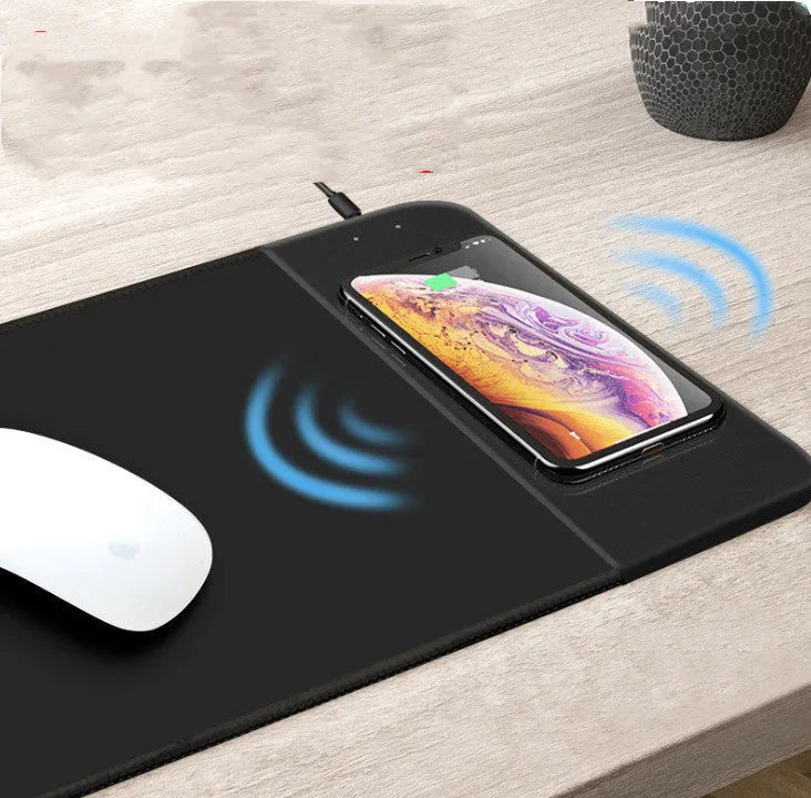 Wireless charging mouse pad with cartoon design showing RGB lighting and USB cable connection