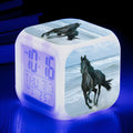 Small colourful square LED alarm clock showing digital time display on plexiglass mirror front