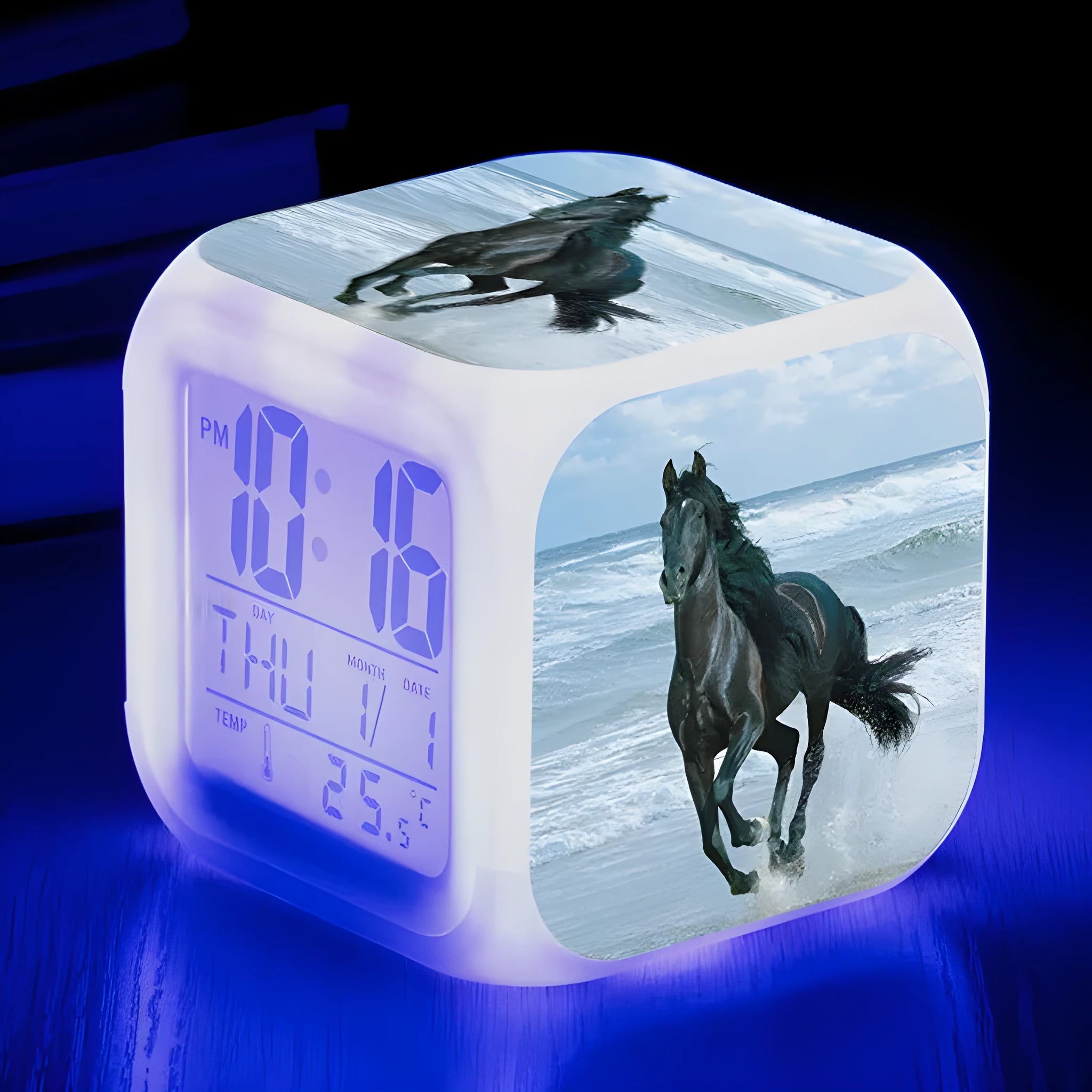 Small colourful square LED alarm clock showing digital time display on plexiglass mirror front