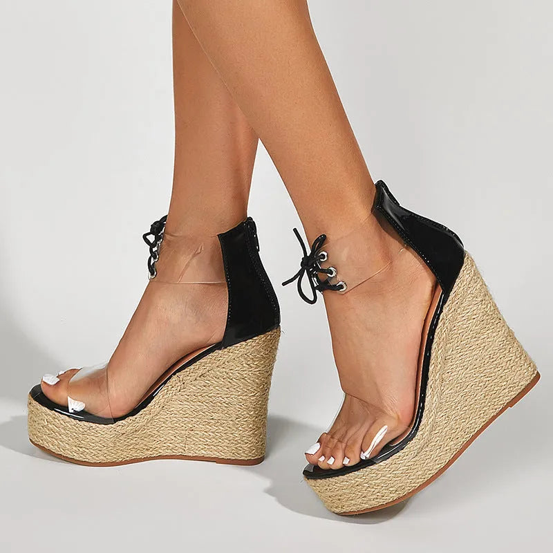 Black women's wedge sandals with a high hemp rope wedge heel and front tie strap.