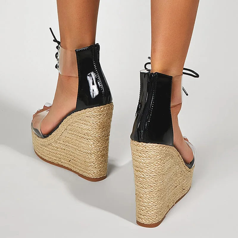 Black women's wedge sandals with a high hemp rope wedge heel and front tie strap.