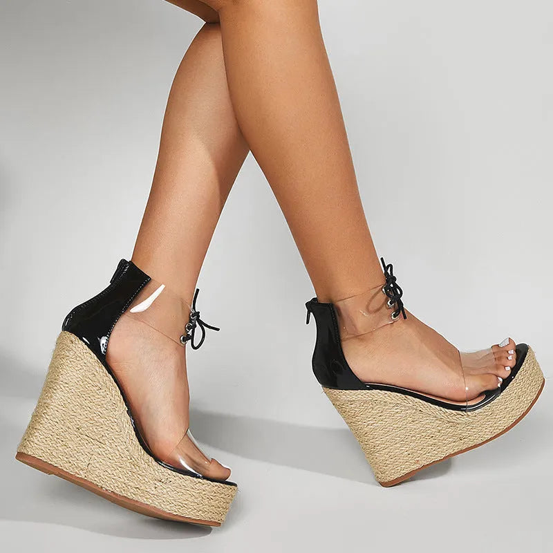 Black women's wedge sandals with a high hemp rope wedge heel and front tie strap.