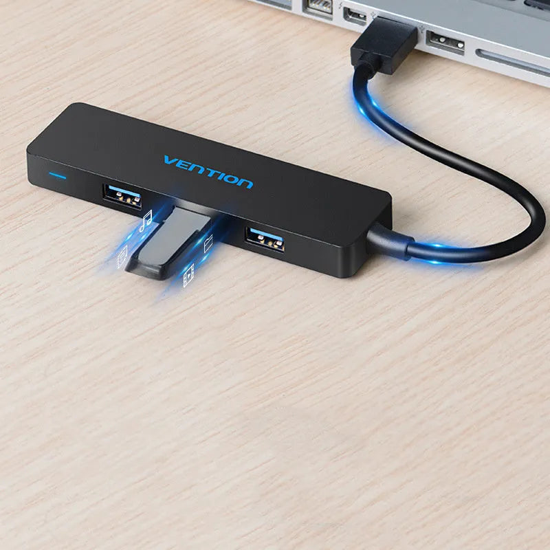 Black four-port USB 3.0 hub with a short connected cable on a white background