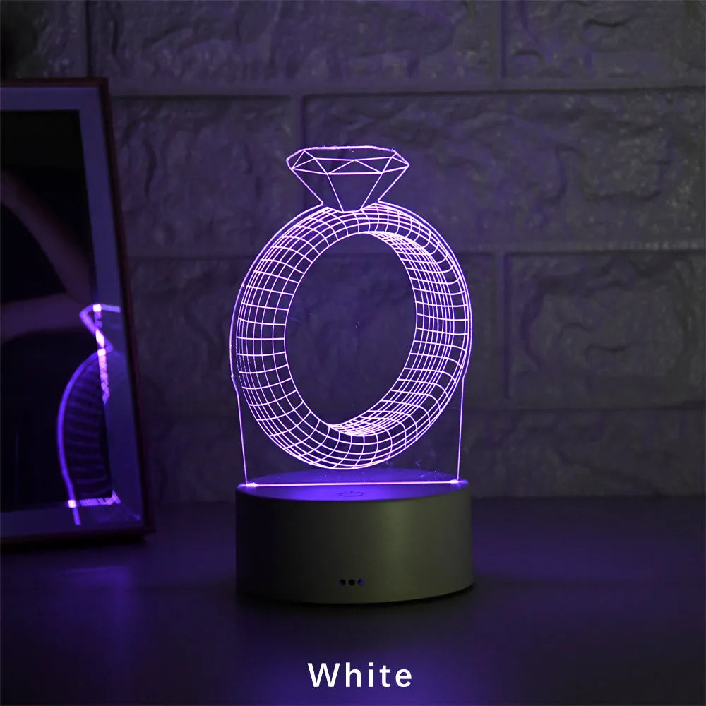 3D stereoscopic LED night light showing an illuminated diamond ring design on a black, white, or cracked white background.
