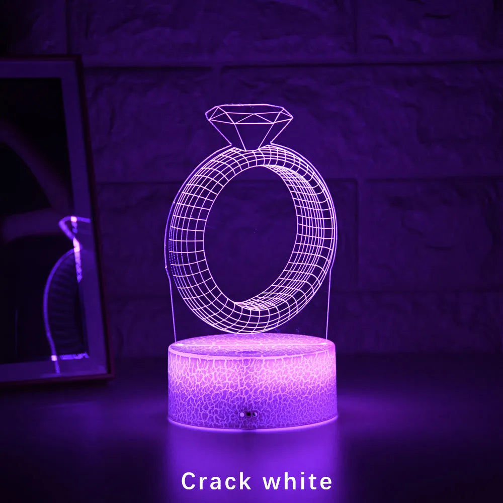 3D stereoscopic LED night light showing an illuminated diamond ring design on a black, white, or cracked white background.