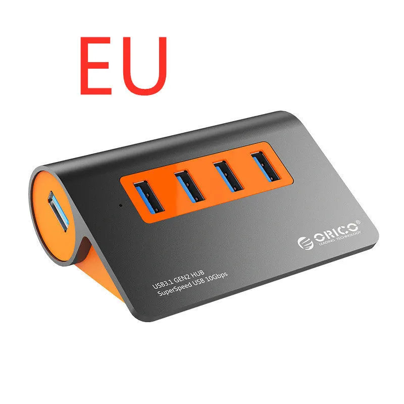 Dark grey aluminium alloy USB 3.1 laptop hub with four ports, orange accents, and detachable cable