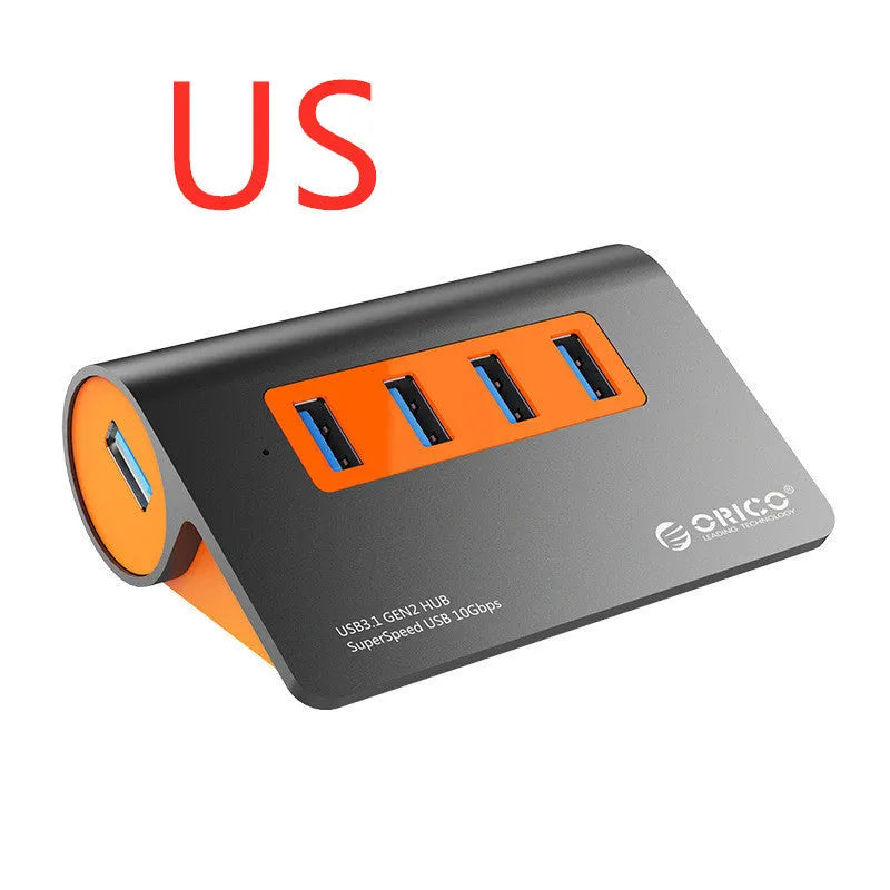 Dark grey aluminium alloy USB 3.1 laptop hub with four ports, orange accents, and detachable cable