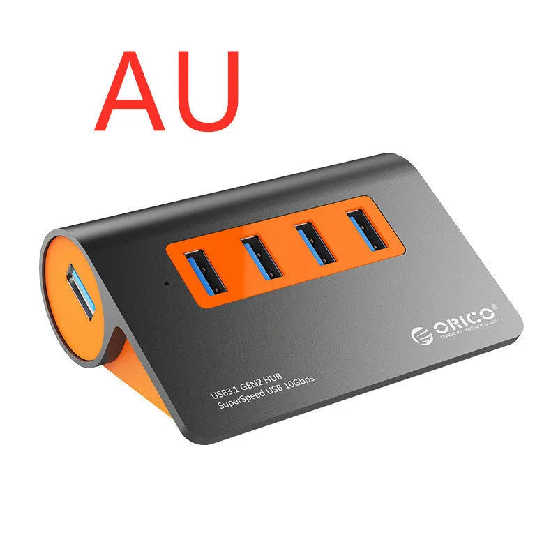Dark grey aluminium alloy USB 3.1 laptop hub with four ports, orange accents, and detachable cable