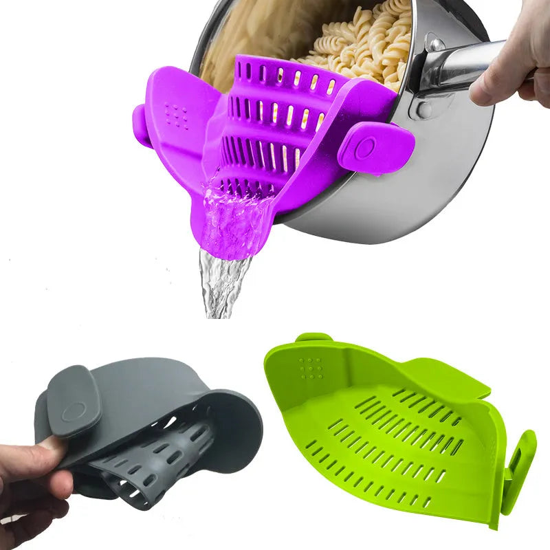 Silicone clip-on funnel strainer attached to a pot rim, showing hollow design and stainless steel buckle.