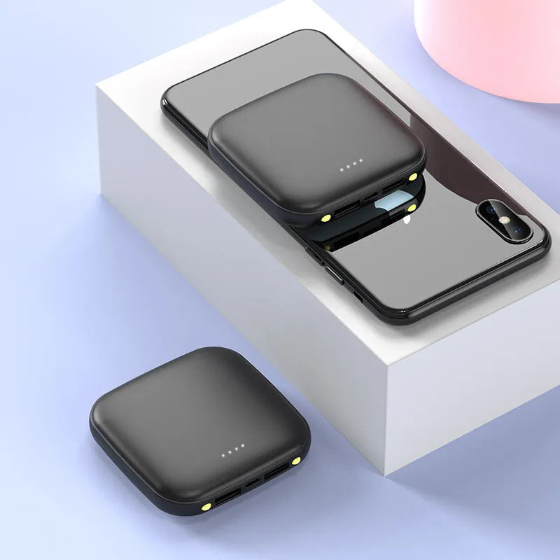 Compact black power bank showing 20000mAh capacity with LED flashlight function