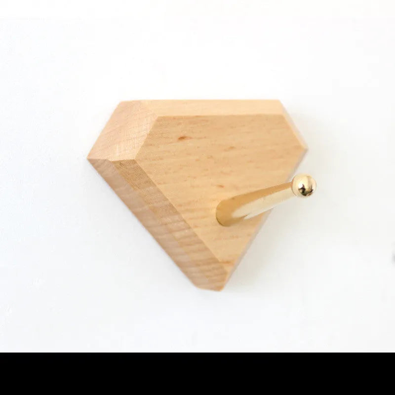 Solid beech wood and brass adhesive wall hook showing five shape options: round, capsule, oval, diamond, and square.