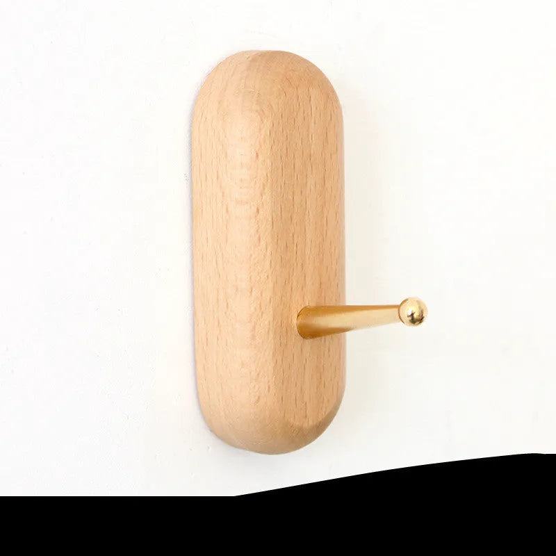 Solid beech wood and brass adhesive wall hook showing five shape options: round, capsule, oval, diamond, and square.