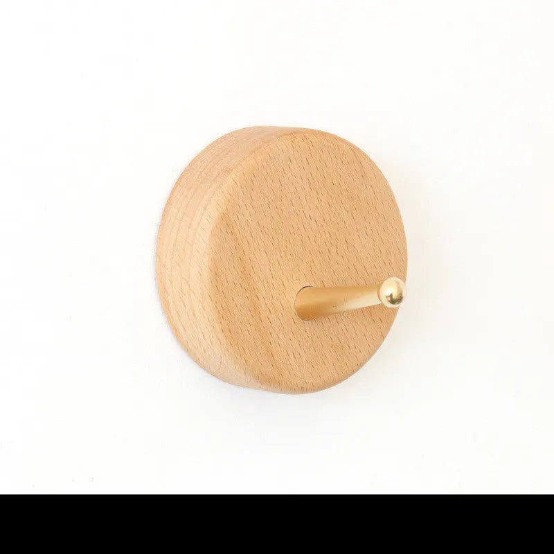 Solid beech wood and brass adhesive wall hook showing five shape options: round, capsule, oval, diamond, and square.