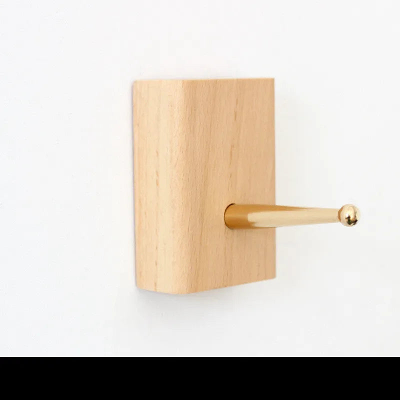 Solid beech wood and brass adhesive wall hook showing five shape options: round, capsule, oval, diamond, and square.