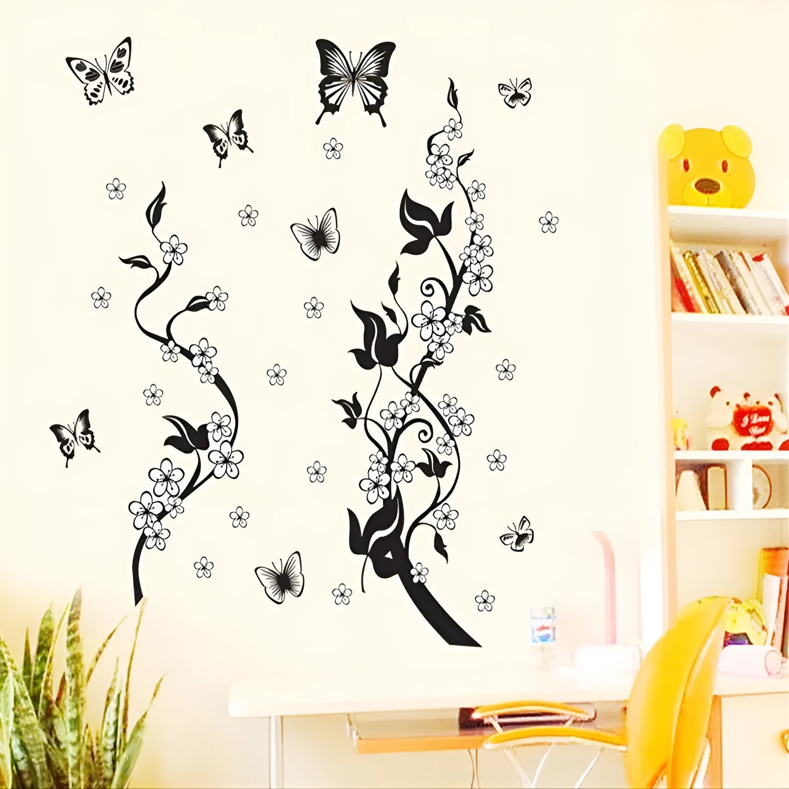 PVC wall sticker showing butterfly and flower design in photo colour on a white wall, size 50x70cm