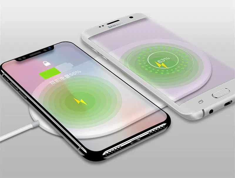 White dual wireless charger charging two mobile phones side-by-side.