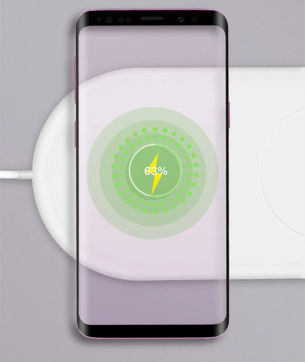 White dual wireless charger charging two mobile phones side-by-side.