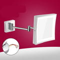 8.5 inch stainless steel folding makeup mirror on a table, shown in silver finish with adjustable angle.